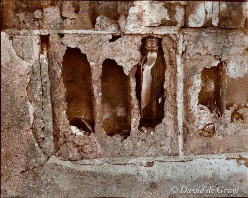 Bottle in a decaying masonry wall, Printing out paper print, gold toned.